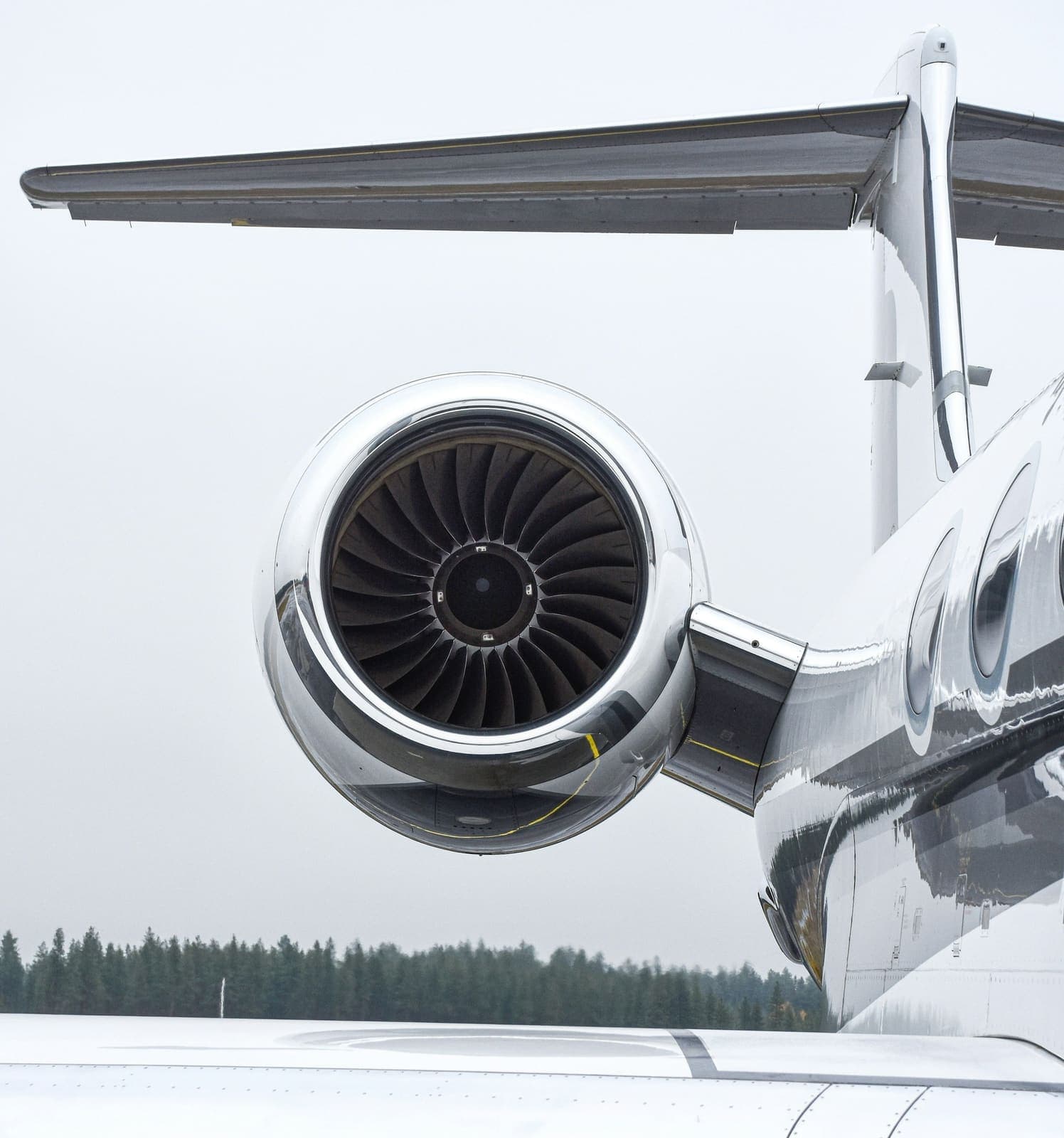 The engine nacelle and wing of a business jet, close up