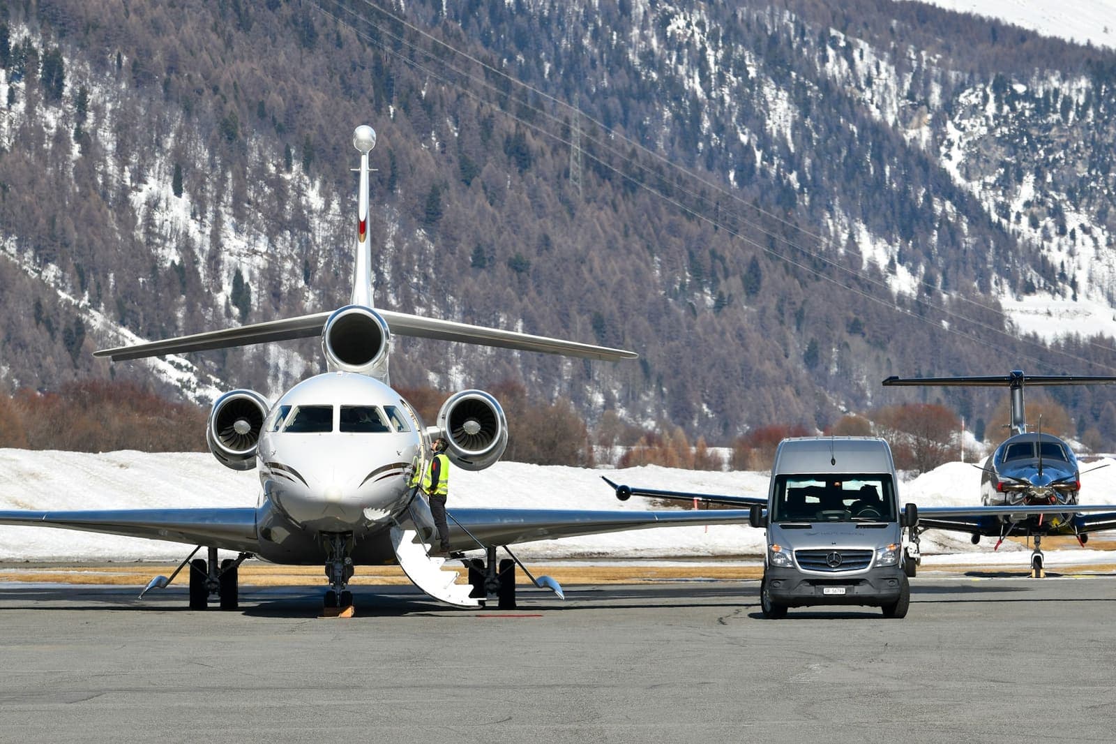 Private jets parked on an airport ramp