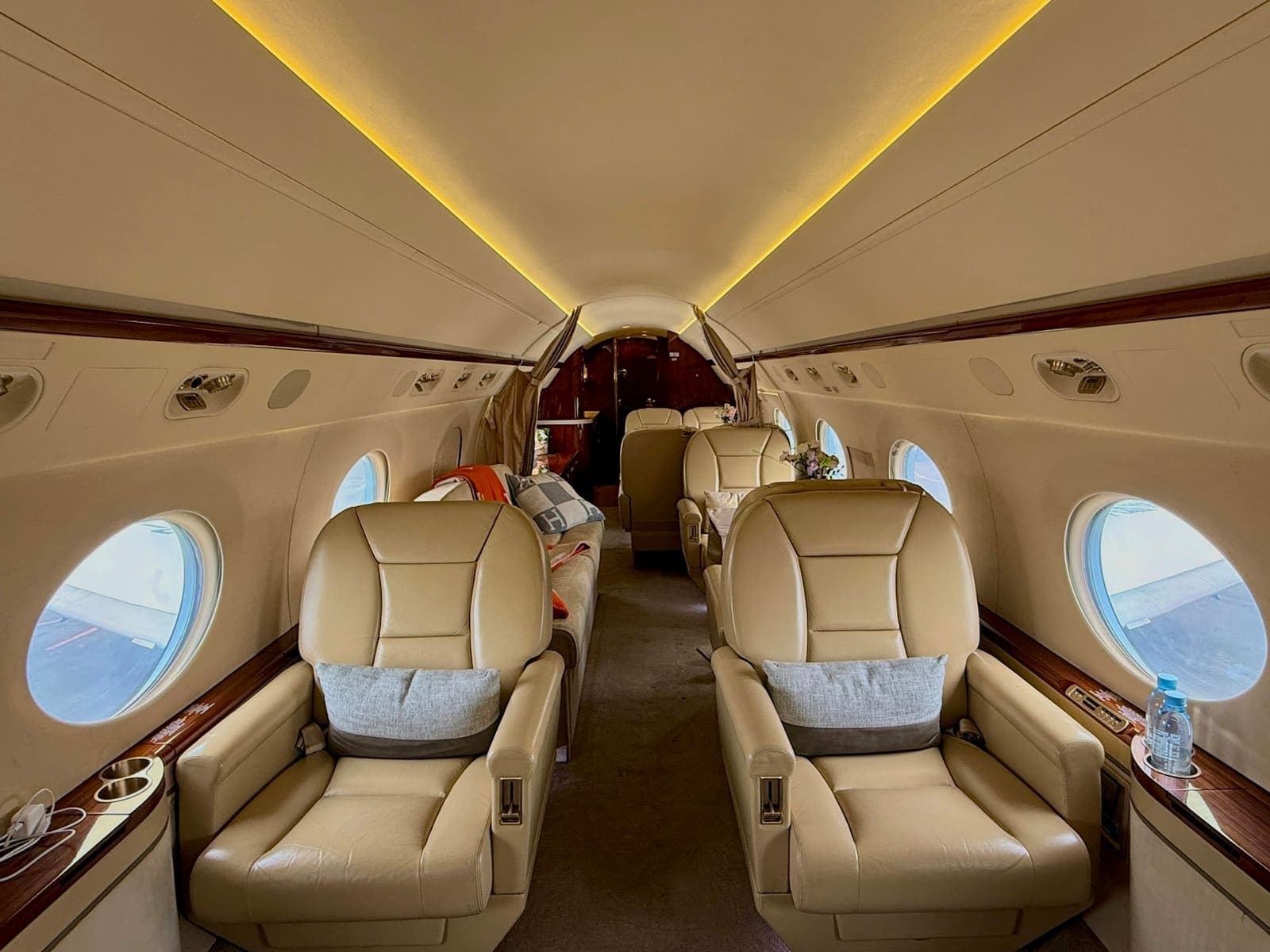 The cabin of a private jet with comfortable leather seating